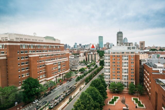 View looking east toward downtown Boston from the new CILSE building. The Questrom School of Business building at the CITGO sign are also visible. The weather is slightly overcast but bright.