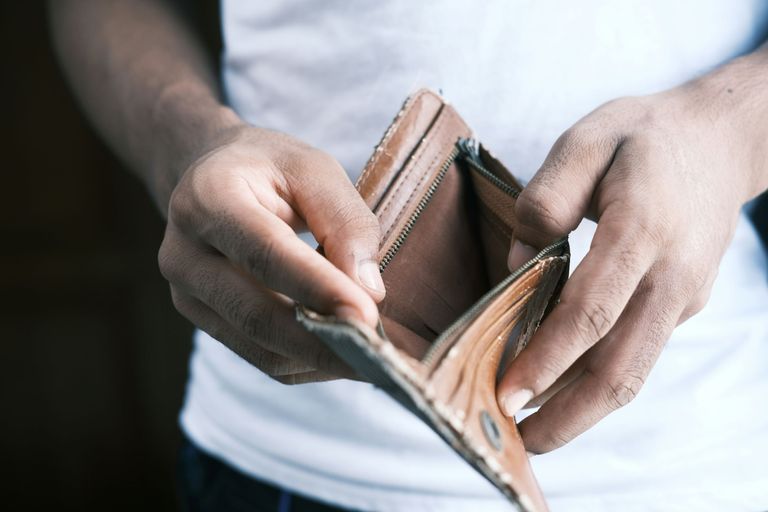 Close up of person opening an empty wallet.
