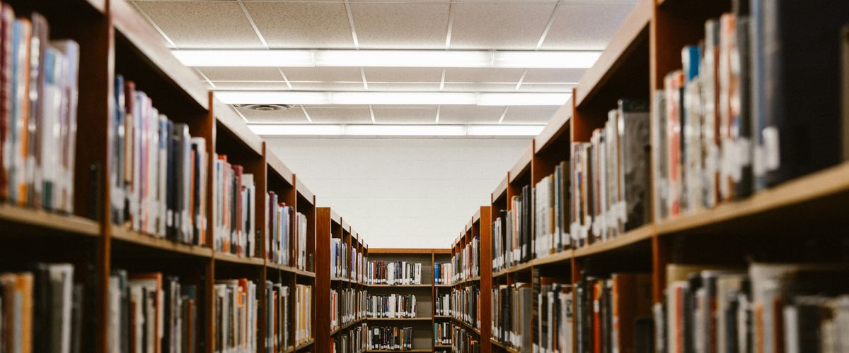 Empty library stacks lit brightly.