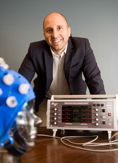 9/20/17 -- Boston, Massachusetts Prof Rob Reinhart has a new paper coming out in PNAS. In his research, he has been able can up-regulate or down-regulate cognitive performance via non-invasive brain stimulation in health humans. Pictured here with some equipment including a high definition cranial electrical current stimulator. Photo by Cydney Scott for Boston University Photography