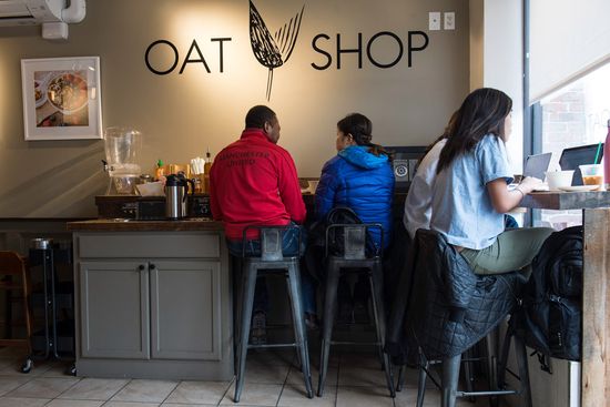 Customers sit at the countertop in Oat Shop.