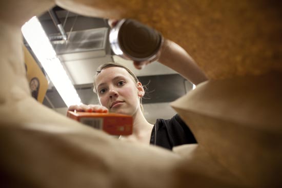 Boston University student Allison Thommaseau puts together packages of food at "Food and Friends" food bank in NE Washington.