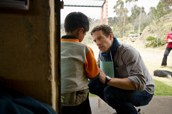 Owen Kendall, BU MED student inspects a boy's cut