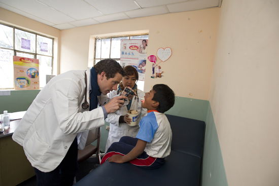 Owen Kendall and Patricia Reátegui examine a Cacha boy.