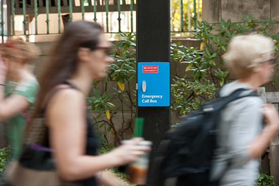Students walk by Boston University Police Department BUPD Emergency Call Box