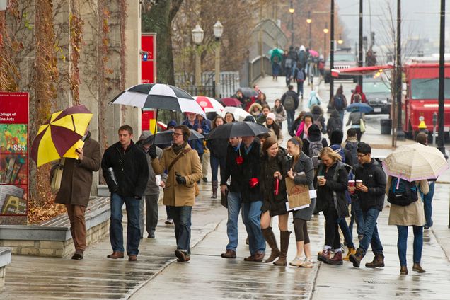 Students on Commonwealth Ave in the rain, Boston University Charles River campus, student life at BU