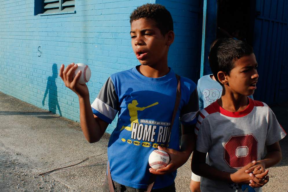 Three boys sell baseballs, Estadio Latinoamericano Three boys sell baseballs, Estadio Latinoamericano, Cuba, photography by Stacey Rupolo