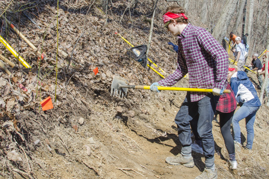 Kevin Flynn uses a McLeod rake to spread mineral soil onto the trail. Photo by Jack Schell (CAS’14)