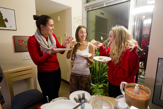 Connie Varela (SMG’17) (from left), Danielle Abourjeili (SMG’17), and Erin Roesch (SMG’17) sample the first latkes off the skillet.