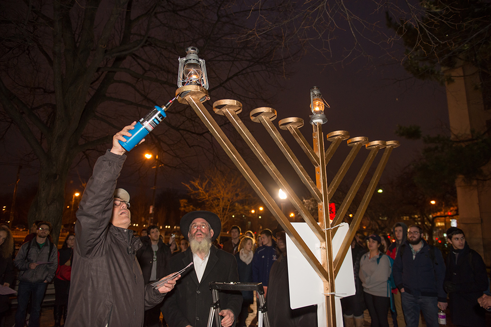 Jack Beermann lighting menorah in Marsh Plaza