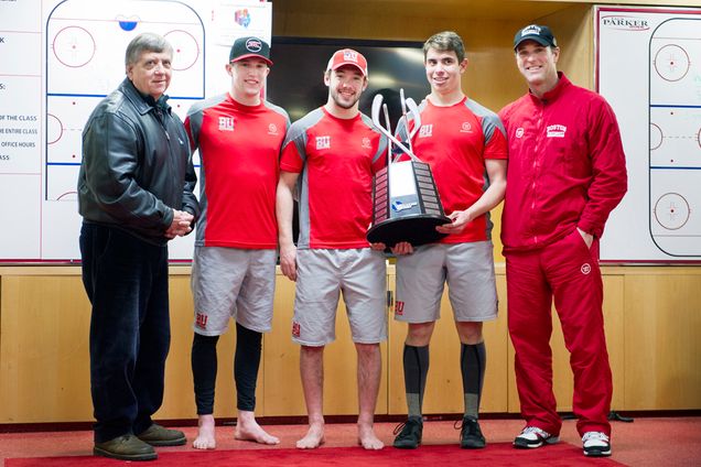 Hockey East Commissioner presents the Men's Hockey Team including captians, Matt Grzelcyk, Cason Hohmann and Evan Rodrigues and Coach David Quinn with a trophy for winning the Hockey East regular season on Wednesday, March 4, 2015. Photo by Jackie Ricciardi