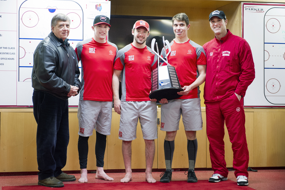 Hockey East Commissioner presents the Men's Hockey Team including captians, Matt Grzelcyk, Cason Hohmann and Evan Rodrigues and Coach David Quinn with a trophy for winning the Hockey East regular season on Wednesday, March 4, 2015. Photo by Jackie Ricciardi
