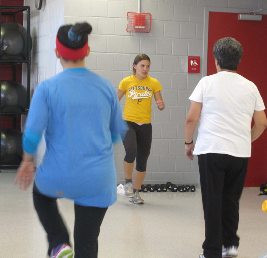 Christina Brigante (SAR’12,’14) leading a physical fitness class for adults over 55 at Blackstone Community Center. Photo by Jean Peteet