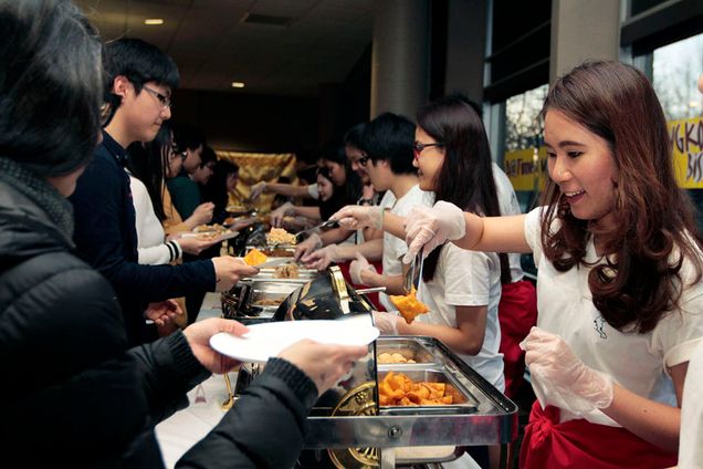 Arakkha Tangsirisatian (COM'17) (right) Thai Festival, food (catered from local Thai restaurants) GSU Backcourt. Photo by Esther Ro (COM'15)