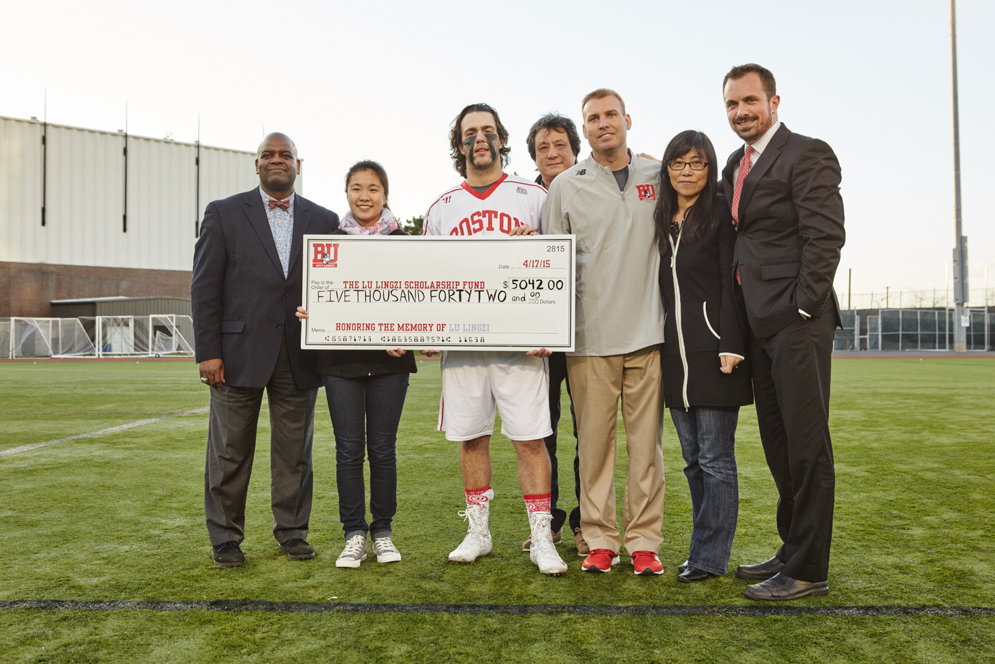 BU Men's Lacrosse presents a check to the family of Lingzi Lu for money raised to benefits the Lu Lingzi Scholarship Fund
