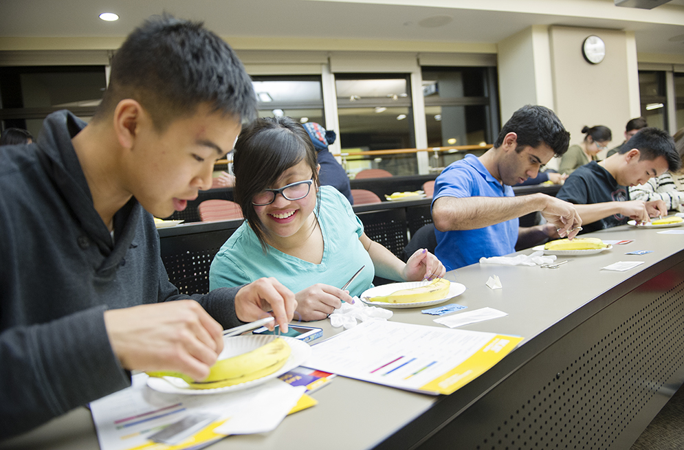 Tammy Chen (SAR'17) checks out Anthony Cheung's (CAS'17) sutures during a suture clinic hosted by Kaplan Test Prep on Wednesday, April 1, 2015. The students used bananas to practice. Photo by Jackie Ricciardi