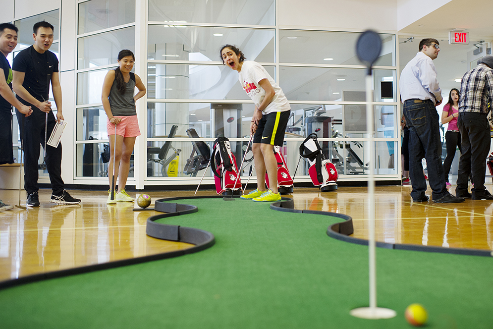 Asma Inam (SAR 15) reacts to missing a hole in one as Jessica Liao (CAS 16), Noah Liu (CAS 17) and Alan Tang (QUESTROM 15) looks on during a mini golf game at Fit Rec on Wednesday, April 15, 2015. Photo by Jackie Ricciardi 
