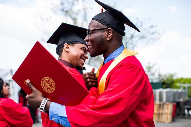 Harrison Grant Meacham (CFA '15) hugs Jeray Thelwell (ENG '15) after meeting up on the way to line up for Commencement. Photo by Kristyn Ulanday 