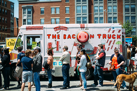The return of the South End Open Market (formerly the SoWa Open Market) is a sure sign that summer is near. Hungry Bostonians line up for food truck delicacies—like those offered by the Bacon Truck—at the food truck market. Photo by Seth Nenstiel photography