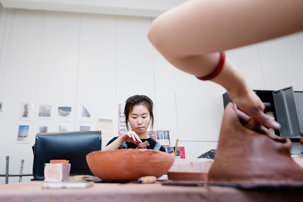 a student works on a new bowl in ceramics class at Boston University