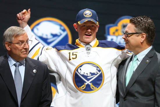 Jack Eichel celebrates with team executives after being drafted by the Buffalo Sabres