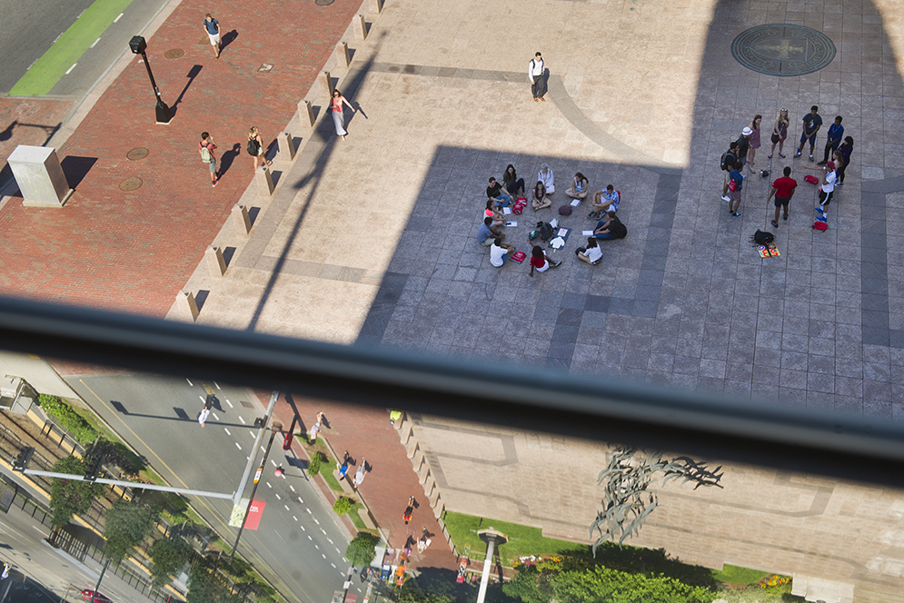 Marsh Plaza reflects in a top floor window in CAS as orientation activities continue June 25, 2015. Photo by Cydney Scott