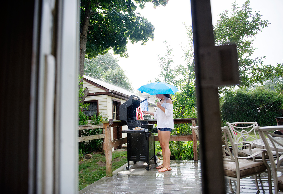 Jessica Silva cooking on the grill in the rain