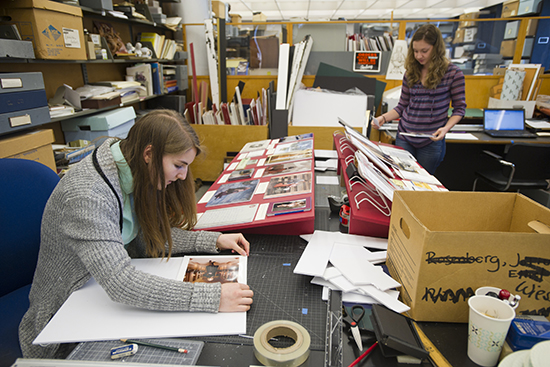 At the Gotlieb Archival Research Center, interns Rebecca Behrends (CAS'17), left, and Ericka Crankshaw (CAS'18) make the display featuring opera singer Deborah Voight September 22, 2015. A new program under Linda Wells giving liberal arts graduates some work experience in on-campus jobs, along with a pass/fail class trying to get them to think deeply about work and career in their lives.