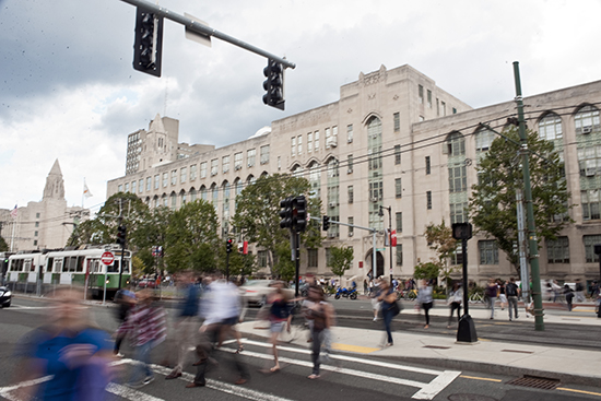 Students cross Commonwealth Ave on the Boston University Charles River Campus