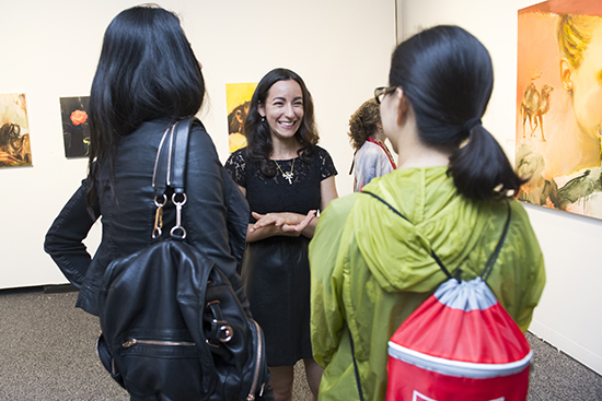 Artist Emily Freiberg (CFA’04) center, greeting guests at the opening reception for Ariel Freiberg: Unquenchable Thirst on view at the Sherman Gallery through October 25. Photo by Jackie Ricciardi