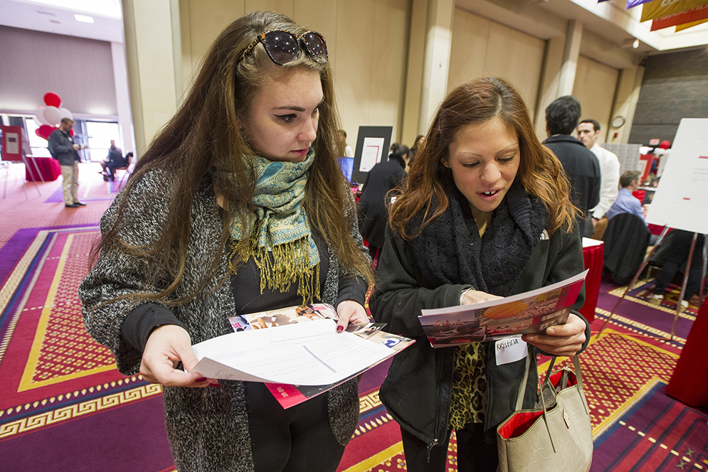 Kayla Decker of Jamaica Plain, left, and Kristina Capuzzi of New York check out their grad school and PhD options at the Graduate & Professional Open House where over 250 programs were represented October 23, 2015 at the GSU. Photo by Cydney Scott