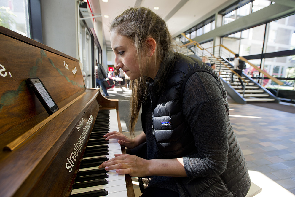Jessie Souza (ENG'19), who was on her way to Mugar Library to study when she detoured for some piano playing, has been playing piano since she was five years old. She was practicing Skinny Love by Birdy thanks to finding the sheet music on her smartphone October 6, 2015. Photo by Cydney Scott