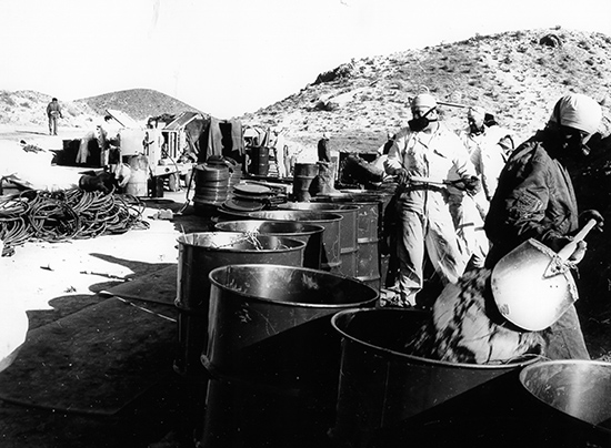 workers shovel radioactive contaminated dirt during the nuclear cleanup in Palomares, Spain