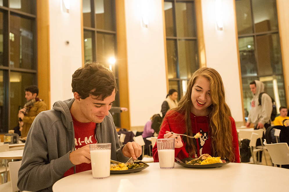 Jacob Aubrecht (Questrom'19) and Jess Jutras (COM'19) dig into a turkey dinner offered at all the campus dining halls November 19, 2015.   Photo by Cydney Scott 