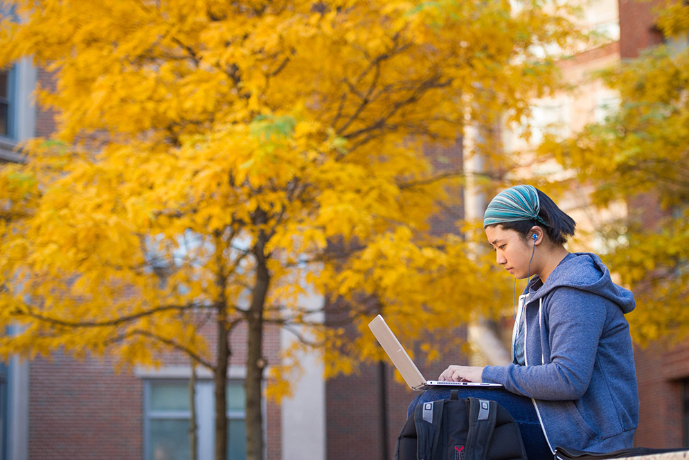 Evangeline Tsai (SAR'19) hits the laptop for a Japanese course in the Metcalf Science Center plaza. Photo by Cydney Scott