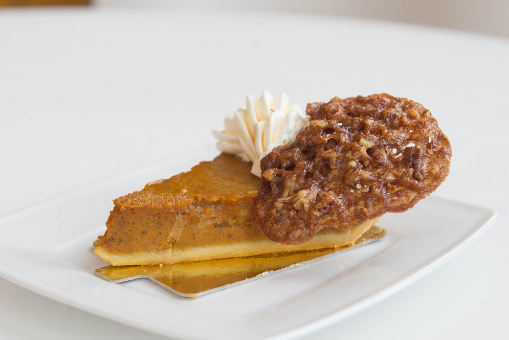 Pumpkin Pie with Caramel drizzle and Pecan Garnish at Rize Bakery