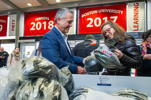 BUPD's Deputy Director of Public Safety Scott Paré replaces Charlotte Johansen's (Pardee School'15) helmet after she shows him her cracked one November 19, 2015 at the GSU. BUDP was handing out bike helmets as part of their Safety Awareness week campaign which continues through Friday at the GSU. Photo by Cydney Scott
