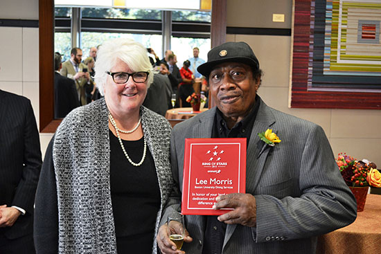 Dining Services director Barbara Laverdiere presents Lee Morris with Aramark’s Ring of Stars award October 26 in recognition of 55 years of service to BU. Photo courtesy of BU Dining Services