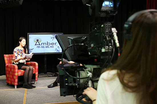 Qinger Lin (CAS’18) (right), frames her camera on news anchor Yuchen Fang (COM’17) at a rehearsal. Photos by Smaranda Tolosano (CAS’17)