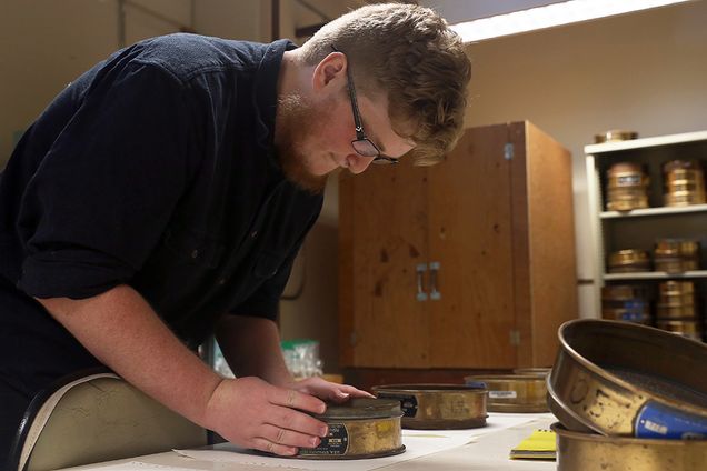Robert Glover (CAS ’17) uses a sieve to measure the size of sand grains he collected on Plum Island beach, Massachusetts, for a sedimentology class project.