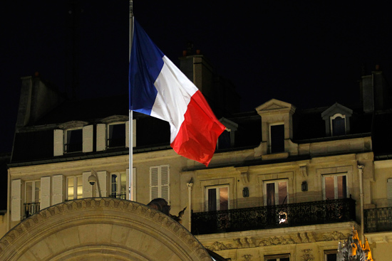 A French flag hangs at half mast at the Elysee Palace on November 15, 2015 in Paris, France.