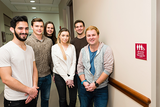 The six Questrom students who got the restrooms’ designation changed are Benji Hadar (Questrom’16) (from left), Alex Paroda (Questrom’16), India Mazzarelli (Questrom’17), Halle Gecawich (Questrom’16), Zach Cracknell (Questrom’16), and Zack Robinson (Questrom’16). Photo by Dana J. Quigley