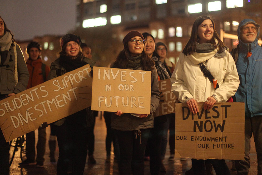 Aine Russell (CAS 17), from left, Brielle Dojer (CAS'16), Monica Gonzalez (Questrom'18) join others during the Students for a Just and Stable Future rally to demonstrate support for the divestment from fossil fuels in Marsh Plaza December 1, 2015. The rally took just before a forum on Climate Change Adaption and Mitigation, hosted by the Board of Trustees' Advisory Committee on Socially Responsible Investing (ASCRI). Photo by Chenyao Xu (COM'17)