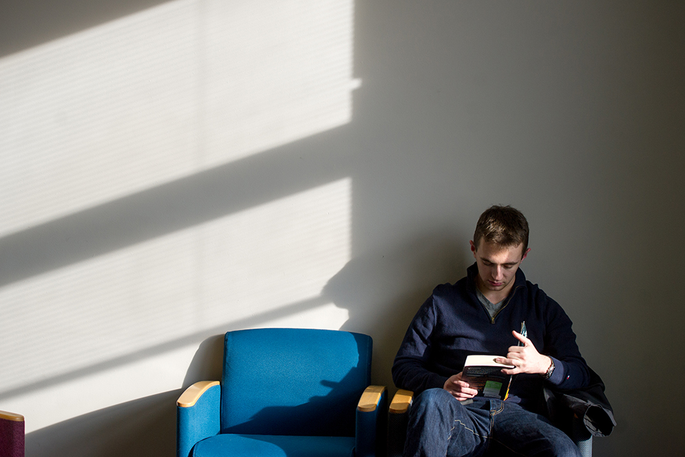Josh Stern (ENG'19) reads Voices In Our Blood for his writing course Rhetoric of American Freedom in the first floor Photonics study lounge January 20, 2016. 