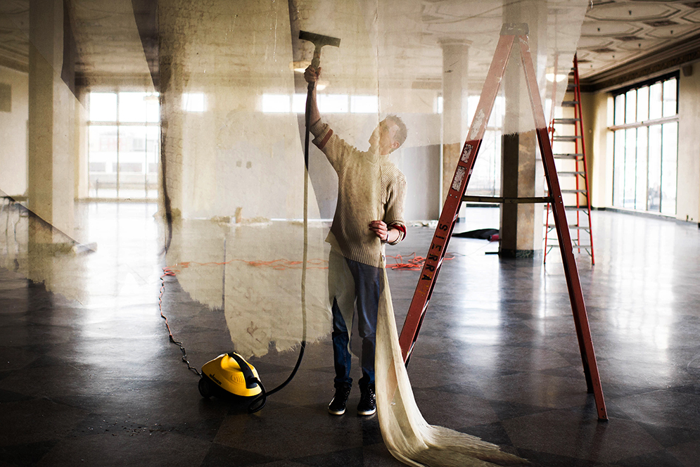 Artist Paul Emmanuel steams his artwork in preparation for his opening "Remnants" at the 808 Gallery on Wednesday, January 27, 2016. Photo by Jackie Ricciardi