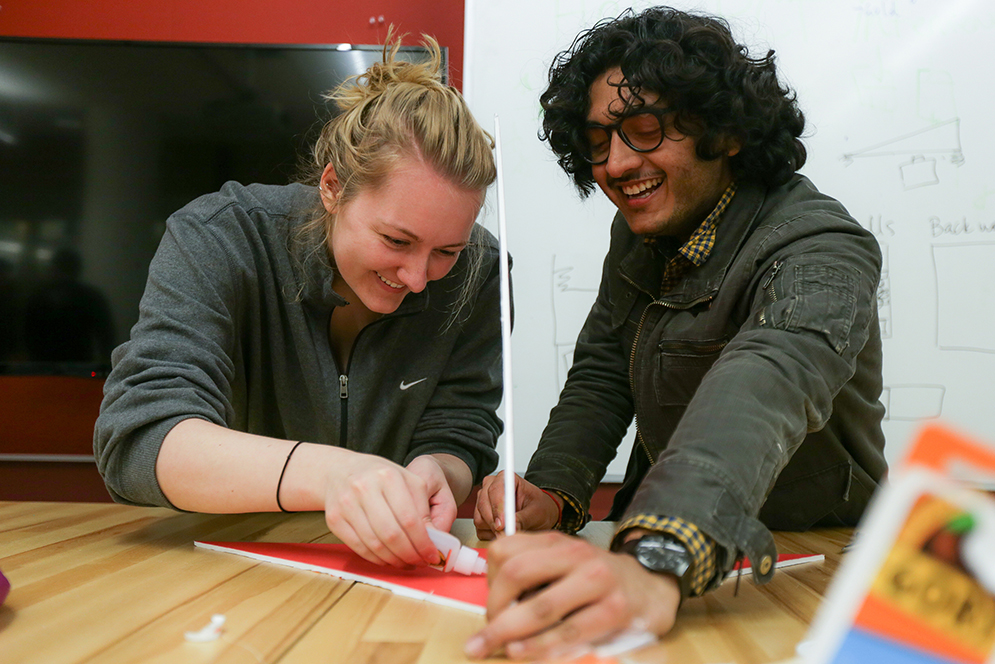 Savan Santoki (ENG '16) (right) and Heather Gamble (ENG '16) work on their airplane during the Extreme Airplane Competition hosted by American Society of Mechanical Engineers in the Engineering Product Innovation Center (EPIC). Photo by Alexandra Wimley (COM'16)