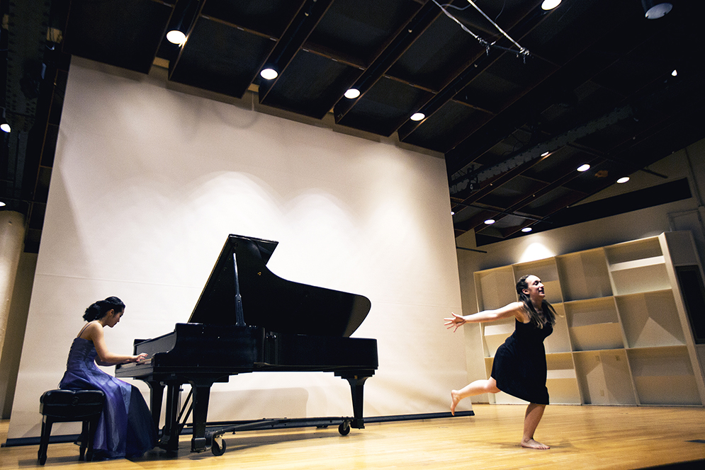 Yui Tiffany Kitamura (CFA '16) (left) and Beverly Diaz (CFA '16) perform in "A Reflection of Heart Melodies" in the College of Fine Arts Concert Hall. The performance combined music, theater and visual arts for a collaborative senior recital. Photo by Alexandra Wimley (COM '17)