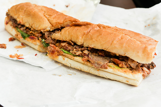 The Heaven is Here sandwich, stuffed with buffalo chicken, roast beef, turkey, bacon, mozzarella, green peppers, pickles, onions, Al’s herbs and spices, vinaigrette, lettuce, and tomato on a baguette, is one of the signature sandwiches at Wan’s Al’s Deli.