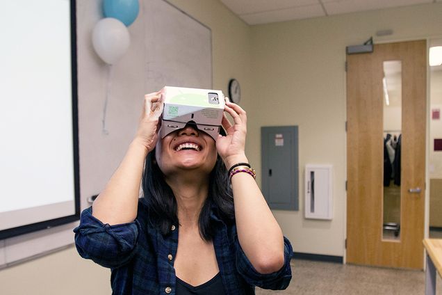 Helen Zhang (CAS '18) takes a break to try out virtual reality glasses during the Global App Initiative's Global Appathon in Boston University's Engineering Product Innovation Center. The glasses were given out as a prize at the end of the day-long appathon. Photo by Alexandra Wimley (COM '17)