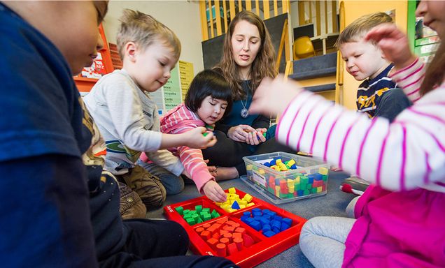 Becky McGhee, BU Children’s Center lead teacher, with a group of three year olds.